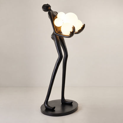 Detail of the glowing glass globes on the Abbraccio floor lamp diffusing warm light