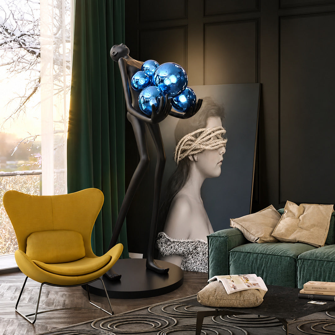 Abbraccio glass floor lamp standing beside a sofa as a sculptural centerpiece in a living room