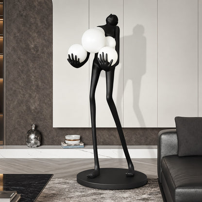 Abbraccio glass floor lamp standing beside a sofa as a sculptural centerpiece in a living room