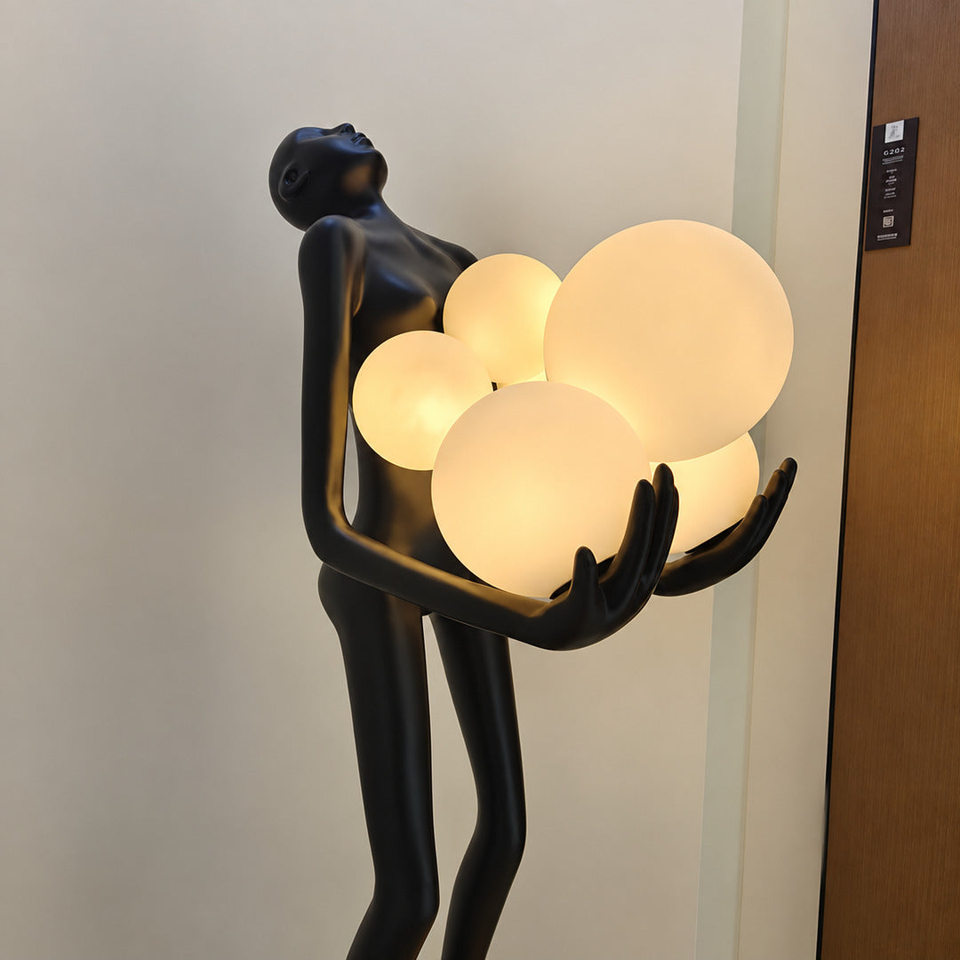 Close-up of the clustered glass globes embraced by the black frame of the Abbraccio floor lamp
