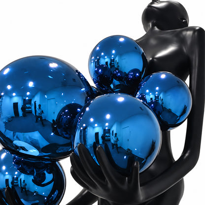 Detail of the glowing glass globes on the Abbraccio floor lamp diffusing warm light