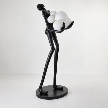 Close-up of the clustered glass globes embraced by the black frame of the Abbraccio floor lamp