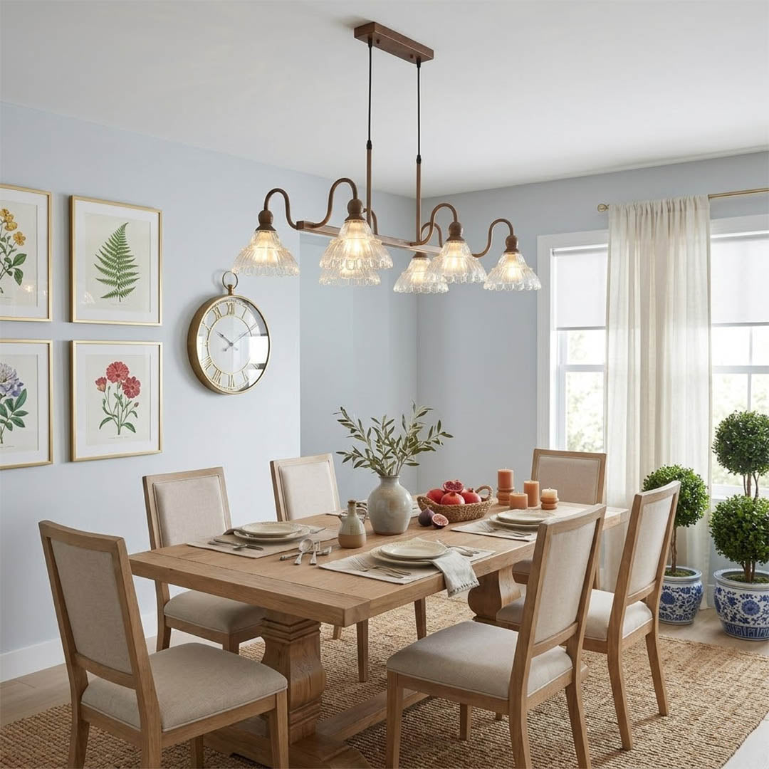Adele linear antique brass chandelier above long rectangular dining table 8 seats vintage glass shades warm modern farmhouse interior