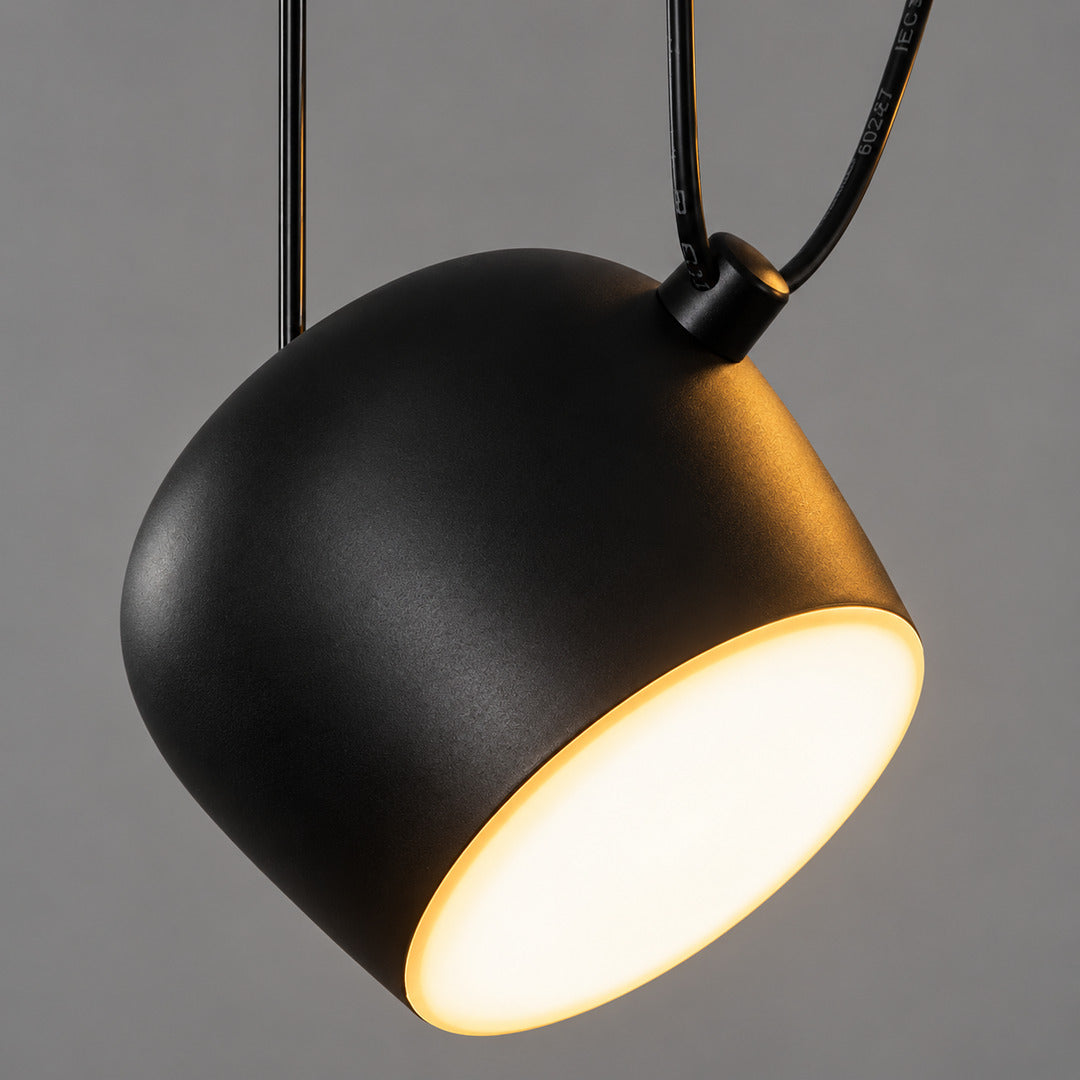 Aim pendant light shown with the shade aimed in several different directions