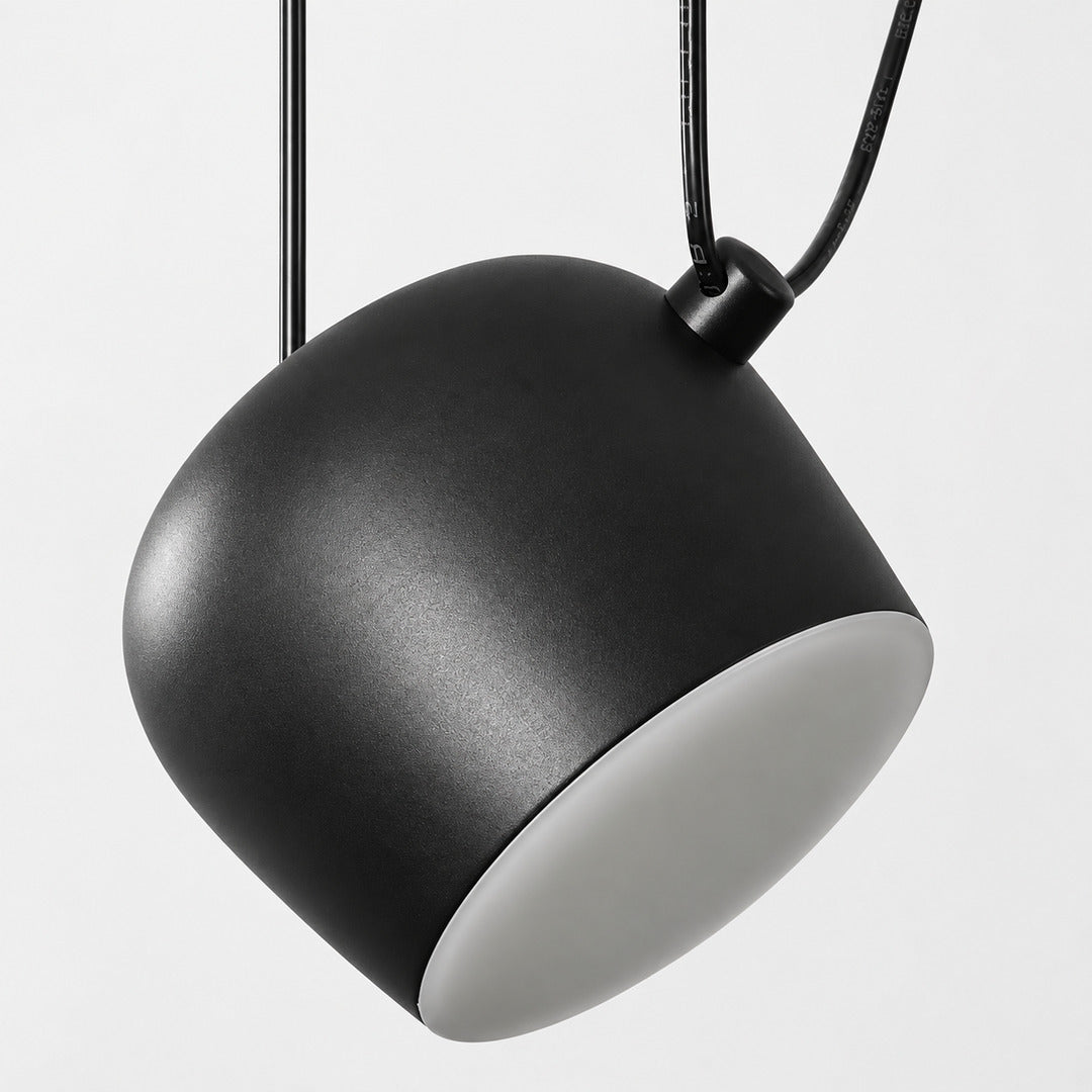 Aim pendant light shown with the shade aimed in several different directions