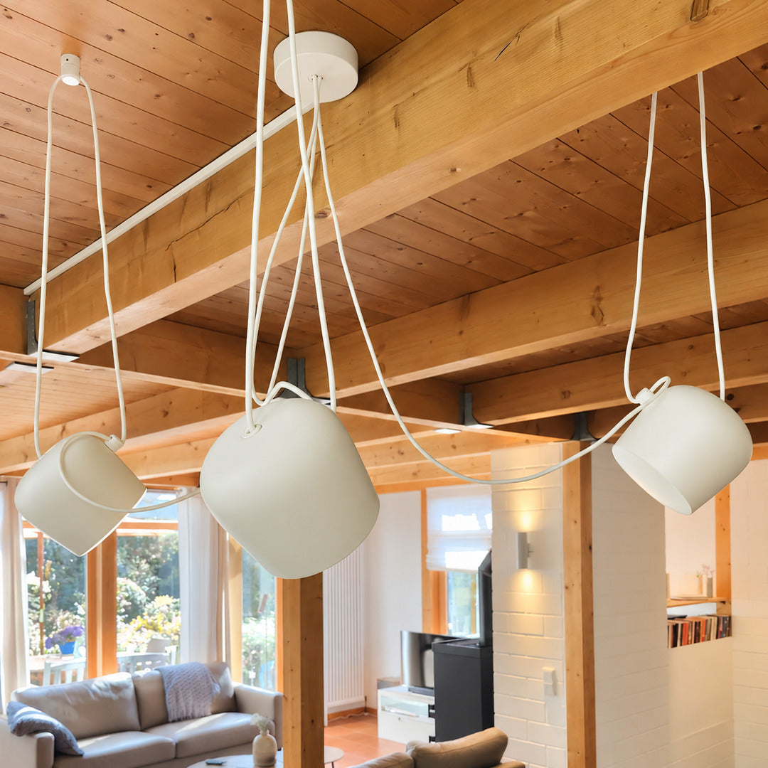 Aim adjustable pendant light as a modern accent over a living room seating area