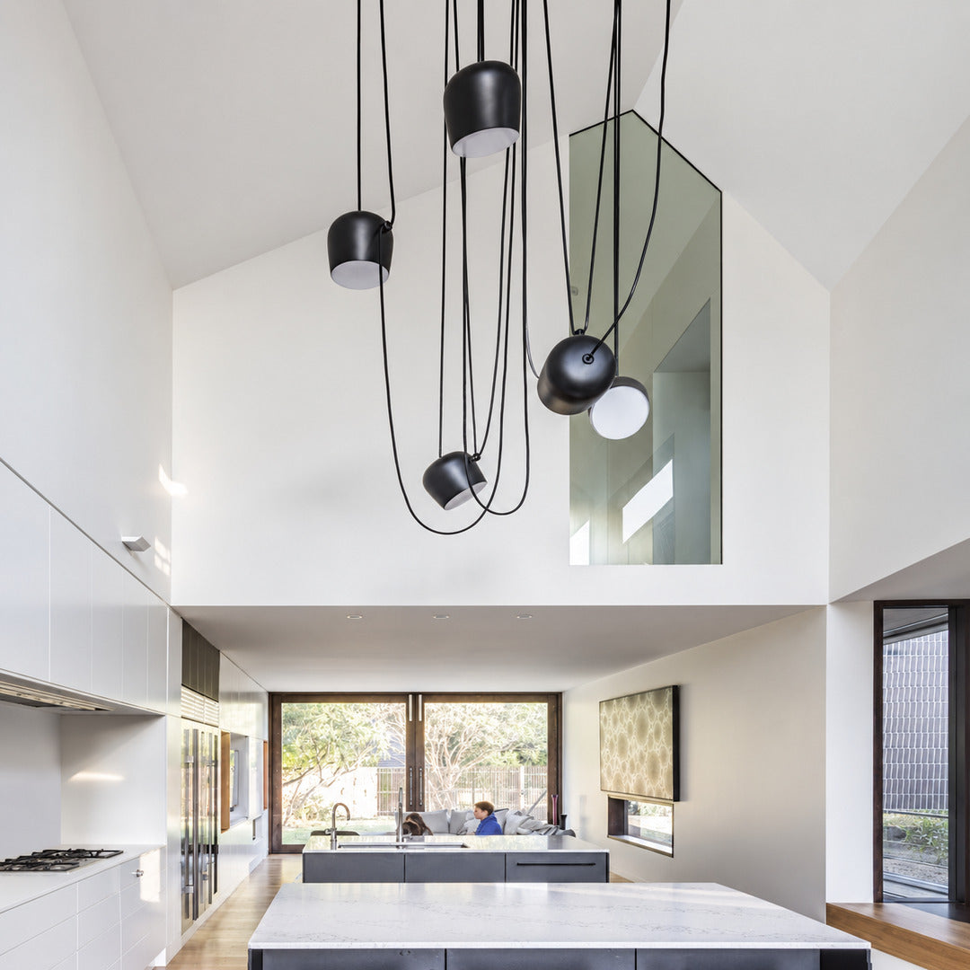 Aim adjustable pendant light as a modern accent over a living room seating area