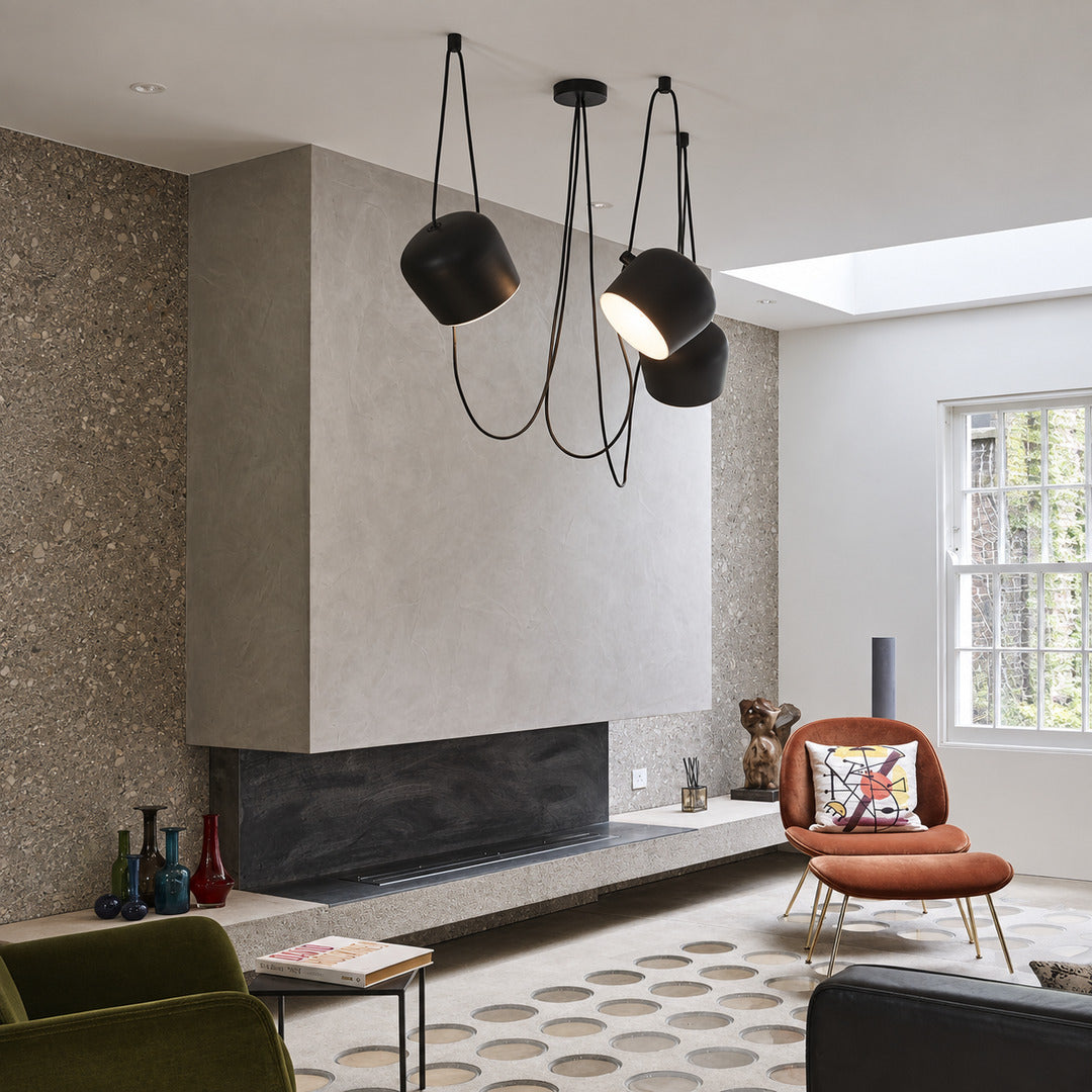 Aim adjustable pendant light as a modern accent over a living room seating area
