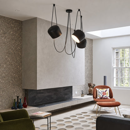 Aim adjustable pendant light as a modern accent over a living room seating area