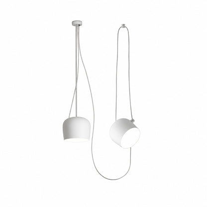 Two-head white Aim pendant light over a dining bar