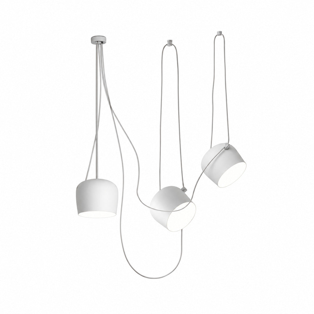 Three-head white Aim pendant light over a dining table