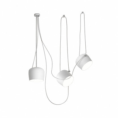 Three-head white Aim pendant light over a dining table
