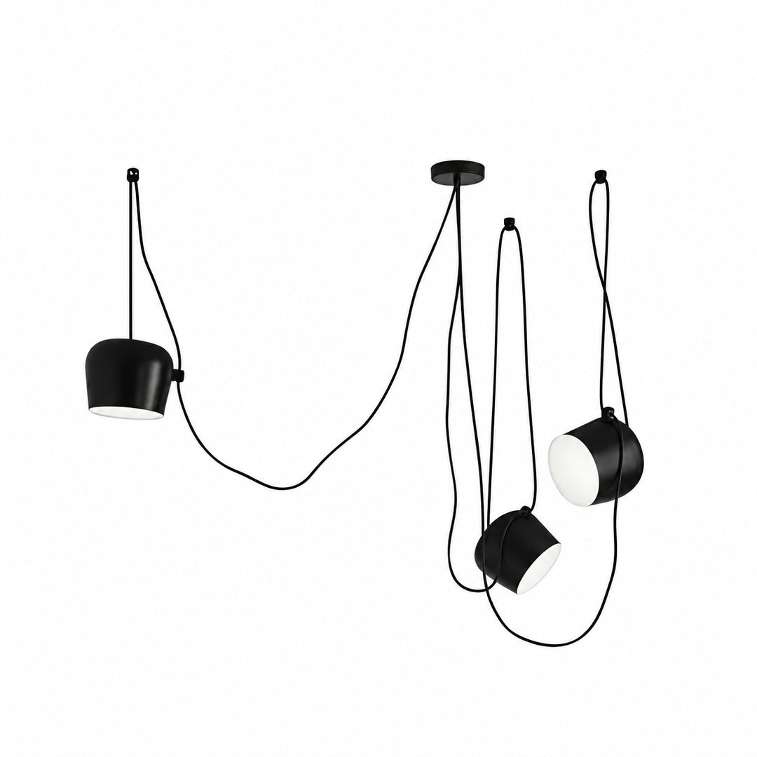 Three-head black Aim pendant light spanning a long kitchen island