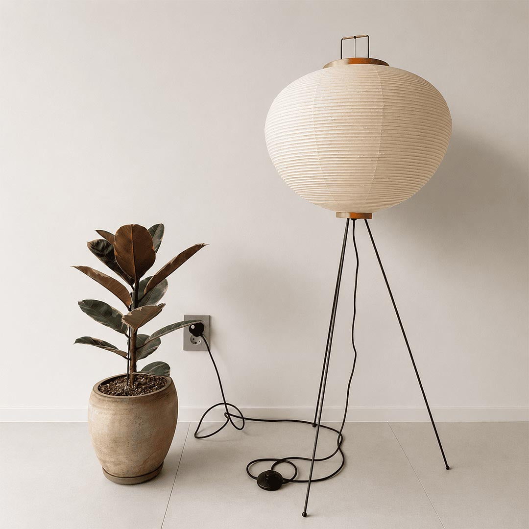 Stuber Lighting tripod paper lantern floor light surrounded by green houseplants, creating a relaxing Wabi-Sabi corner at twilight.