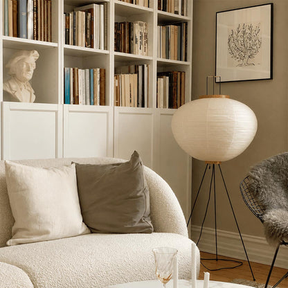 Stuber premium handcrafted off-white washi paper tripod floor lamp with black legs illuminating a modern Japandi living room.