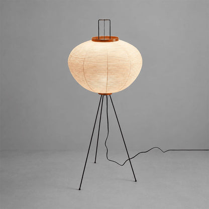 Minimalist Stuber Lighting Japanese rice paper floor lamp with black tripod legs, organic modern lantern standing light on a clean background