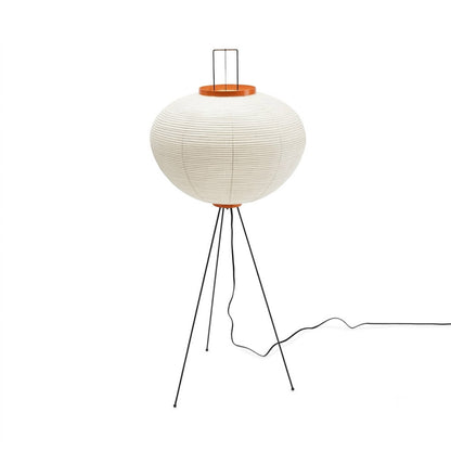 Minimalist Akari 10A floor lamp made of Japanese rice paper with black tripod legs, organic modern lantern standing light on a clean white background by Stuber Lighting.