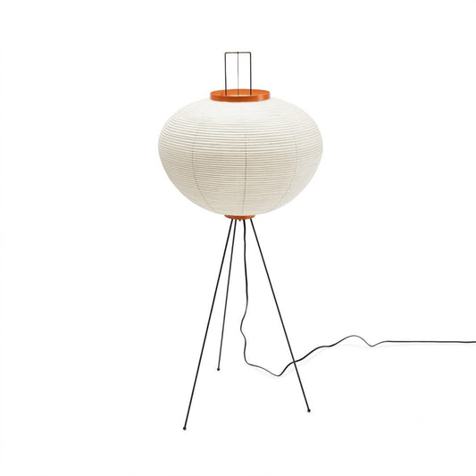 Minimalist Akari 10A floor lamp made of Japanese rice paper with black tripod legs, organic modern lantern standing light on a clean white background by Stuber Lighting.