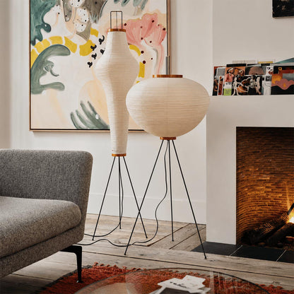 Stuber premium handcrafted off-white washi paper tripod floor lamp with black legs illuminating a modern Japandi living room.