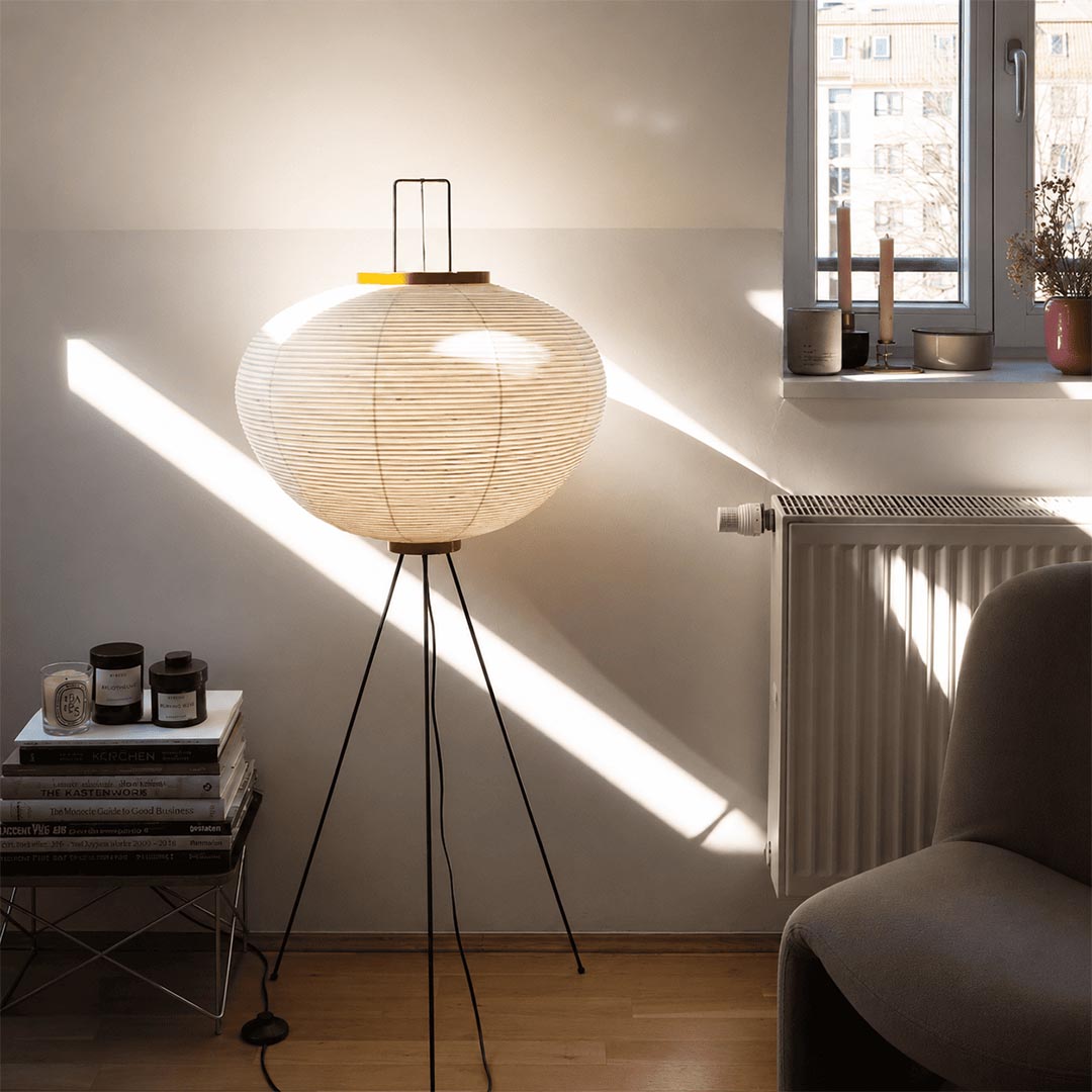 Serene home office workspace illuminated by a Stuber Lighting Japandi style rice paper floor lamp next to a minimalist wooden desk.