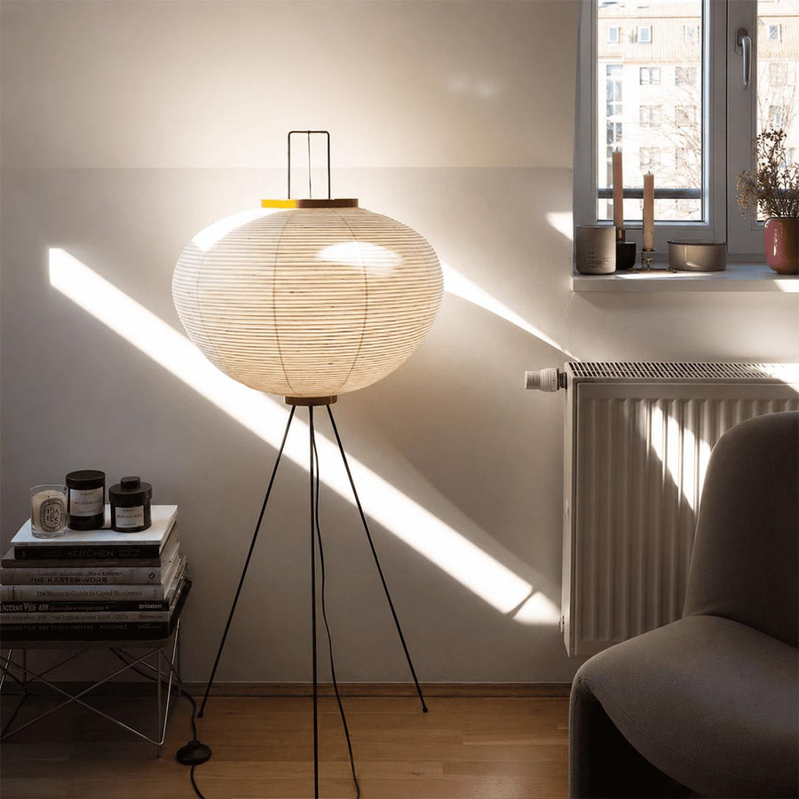 Serene home office workspace illuminated by a Stuber Lighting Japandi style rice paper floor lamp next to a minimalist wooden desk.
