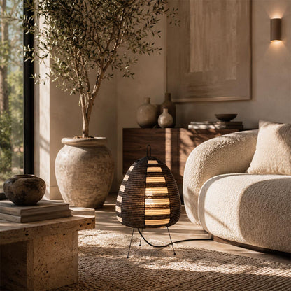 akari a series Washi paper table lamp with black and natural horizontal bands, styled as a floor accent lamp next to a cream bouclé sofa in a Wabi-Sabi living room.