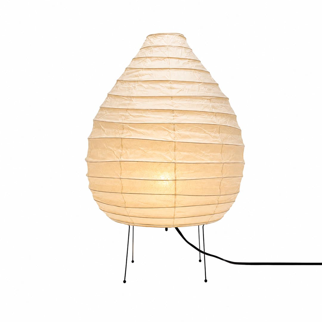 Studio portrait of the warmly glowing onion-shaped Akari 22N Table Lamp on a white backdrop by Stuber Lighting.