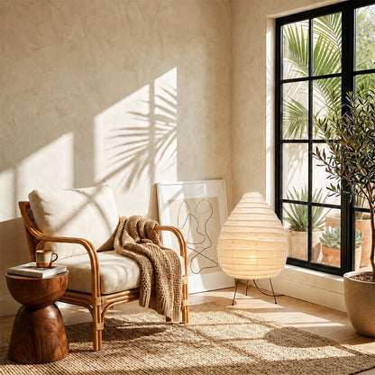 Sunlit Japandi room corner showcasing an Akari 22N Teardrop Lamp next to an accent lounge chair by Stuber Lighting.