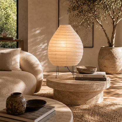 Aesthetic Akari 22N Onion Lamp styled on a texturized coffee table in a sunlit lounge corner by Stuber Lighting.