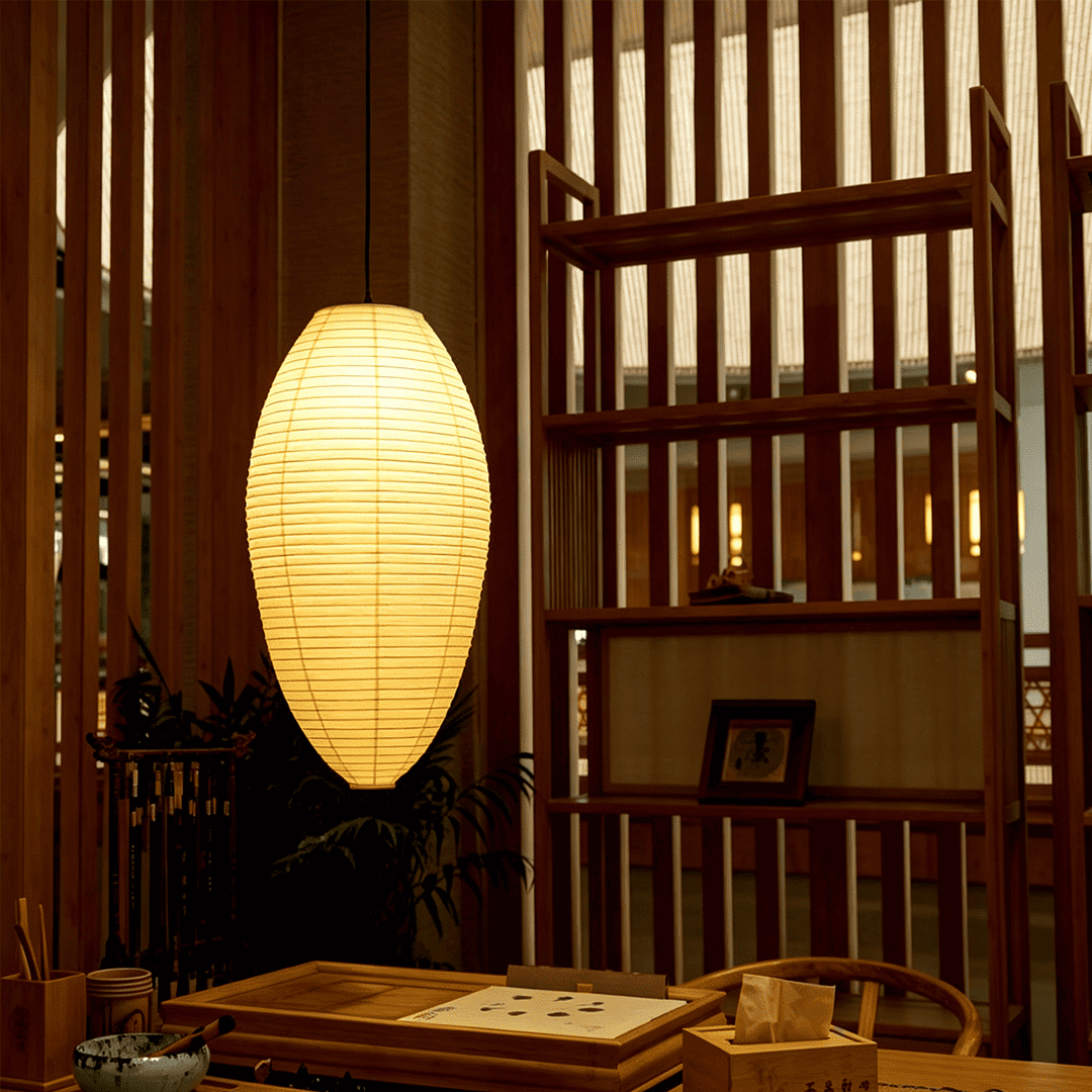 Organic modern dining room setup featuring an oval Akari 23a 24a japandi Washi paper pendant light - Stuber Lighting