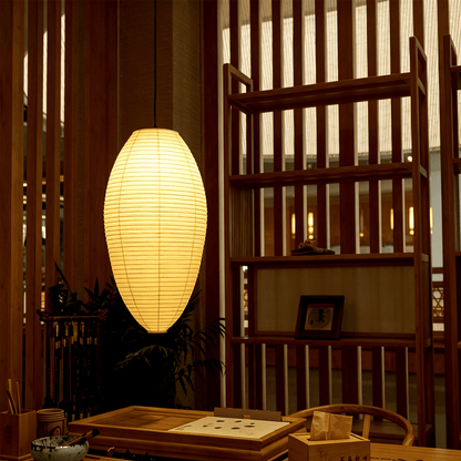 Organic modern dining room setup featuring an oval Akari 23a 24a japandi Washi paper pendant light - Stuber Lighting