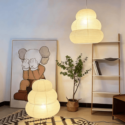Creative living room display featuring Akari 24N pendant lamp and floor lamp combination - Stuber Lighting