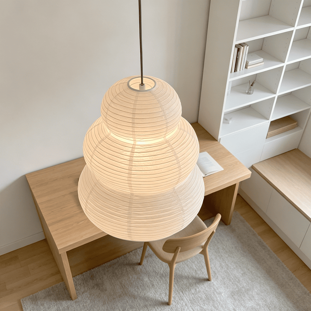 High angle view of Akari 24N paper pendant lamp illuminating a minimalist workspace - Stuber Lighting