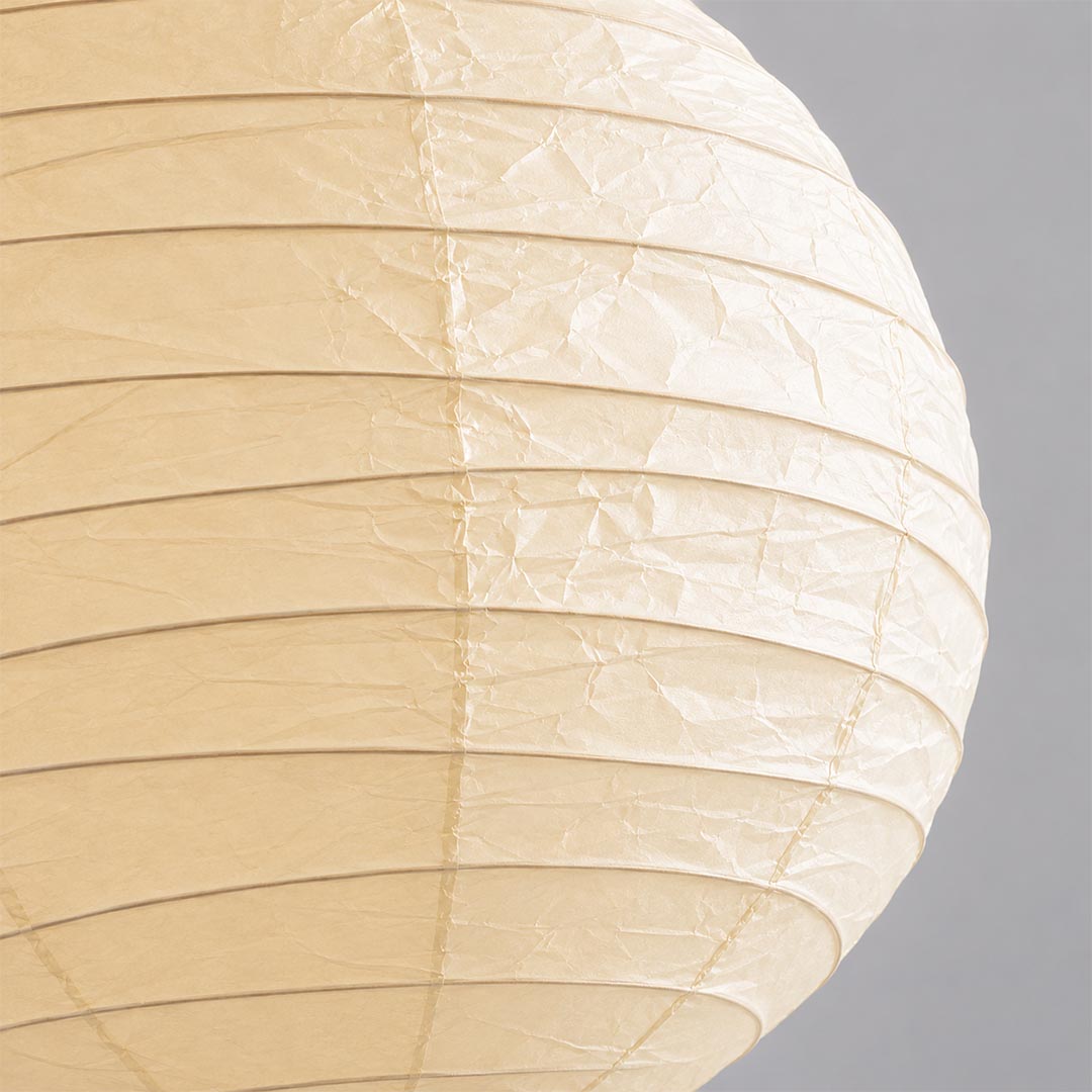 A macro close-up showing the crinkled texture and fine horizontal ribs of a high-quality Washi paper lamp shade in a natural cream color.