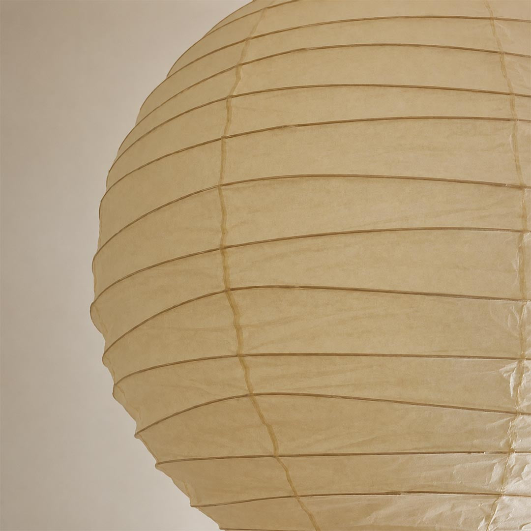 A macro close-up showing the crinkled texture and fine horizontal ribs of a high-quality Washi paper lamp shade in a natural cream color.