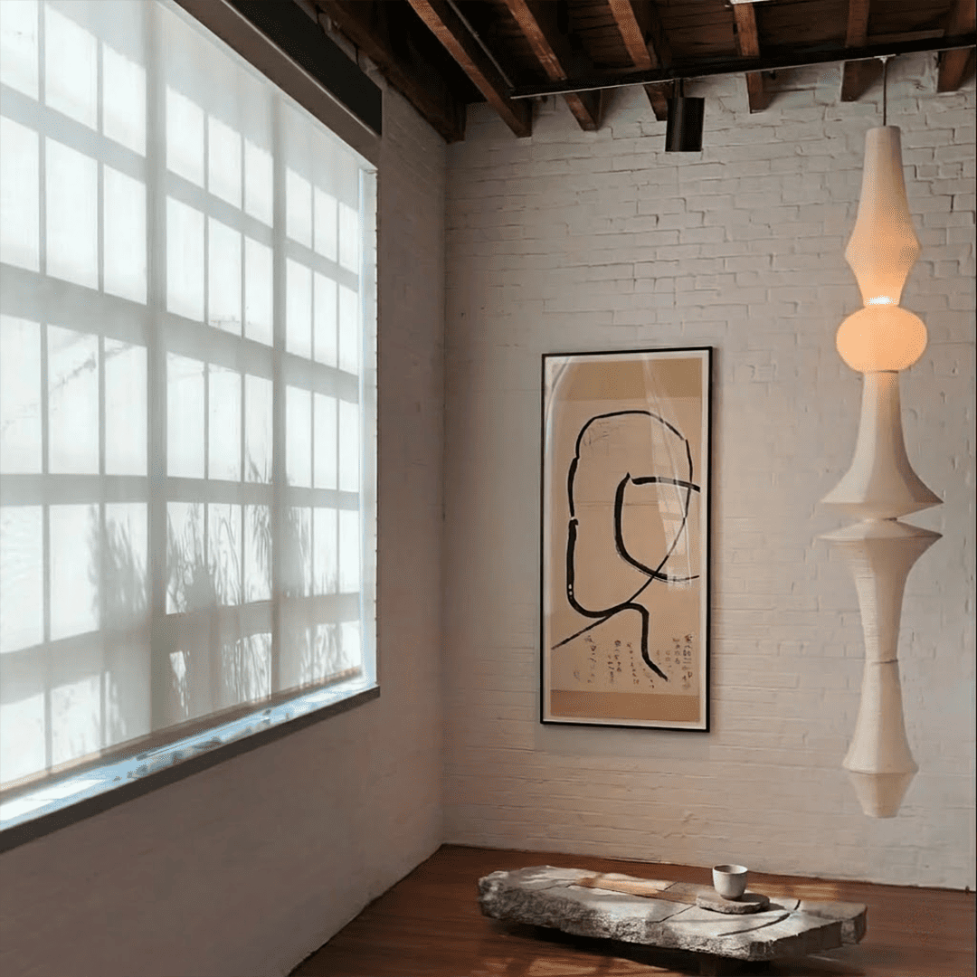 Akari E model pendant light in a minimalist dressing room setting.