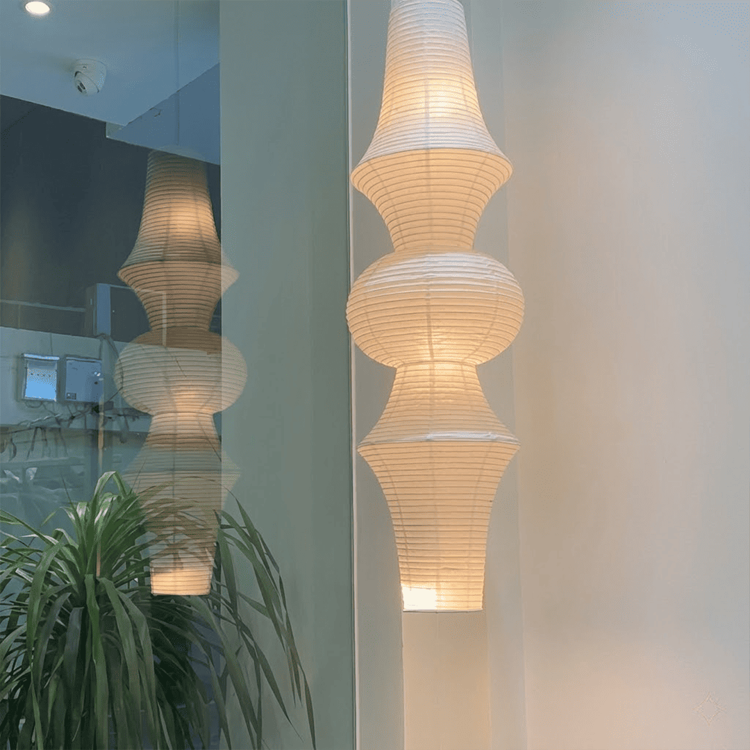 Akari E model pendant light in a minimalist dressing room setting.