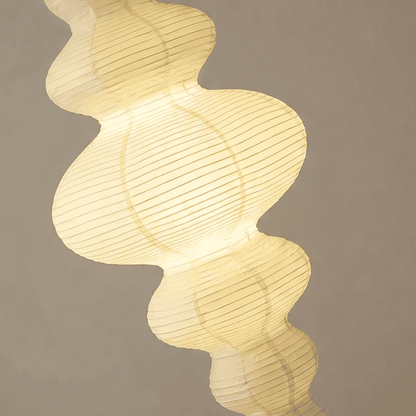 Large Akari Juni washi paper pendant lamp glowing in a minimalist Japandi living room with warm 3000K light.