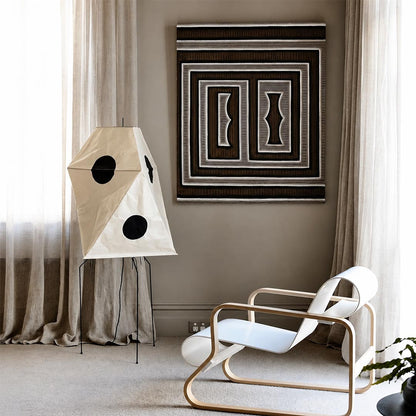 Wabi-Sabi paper lantern floor lamp illuminating a cozy bedroom with sheer beige curtains and lounge chair.