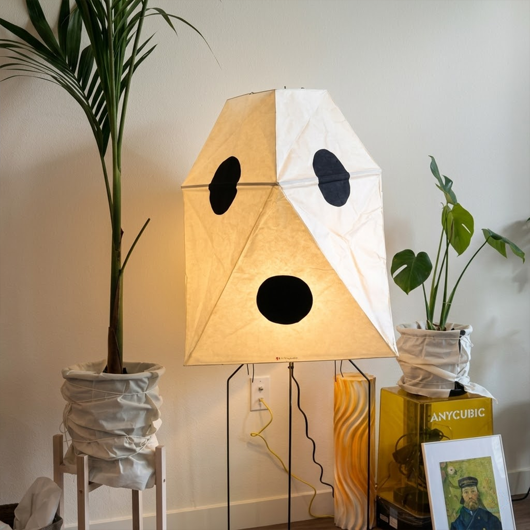 Akari UF3-Q floor lamp in a minimalist Japandi living room next to a designer chair.