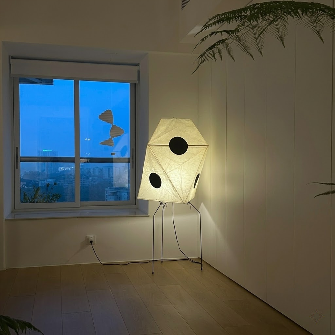 Akari UF3-Q floor lamp in a minimalist Japandi living room next to a designer chair.