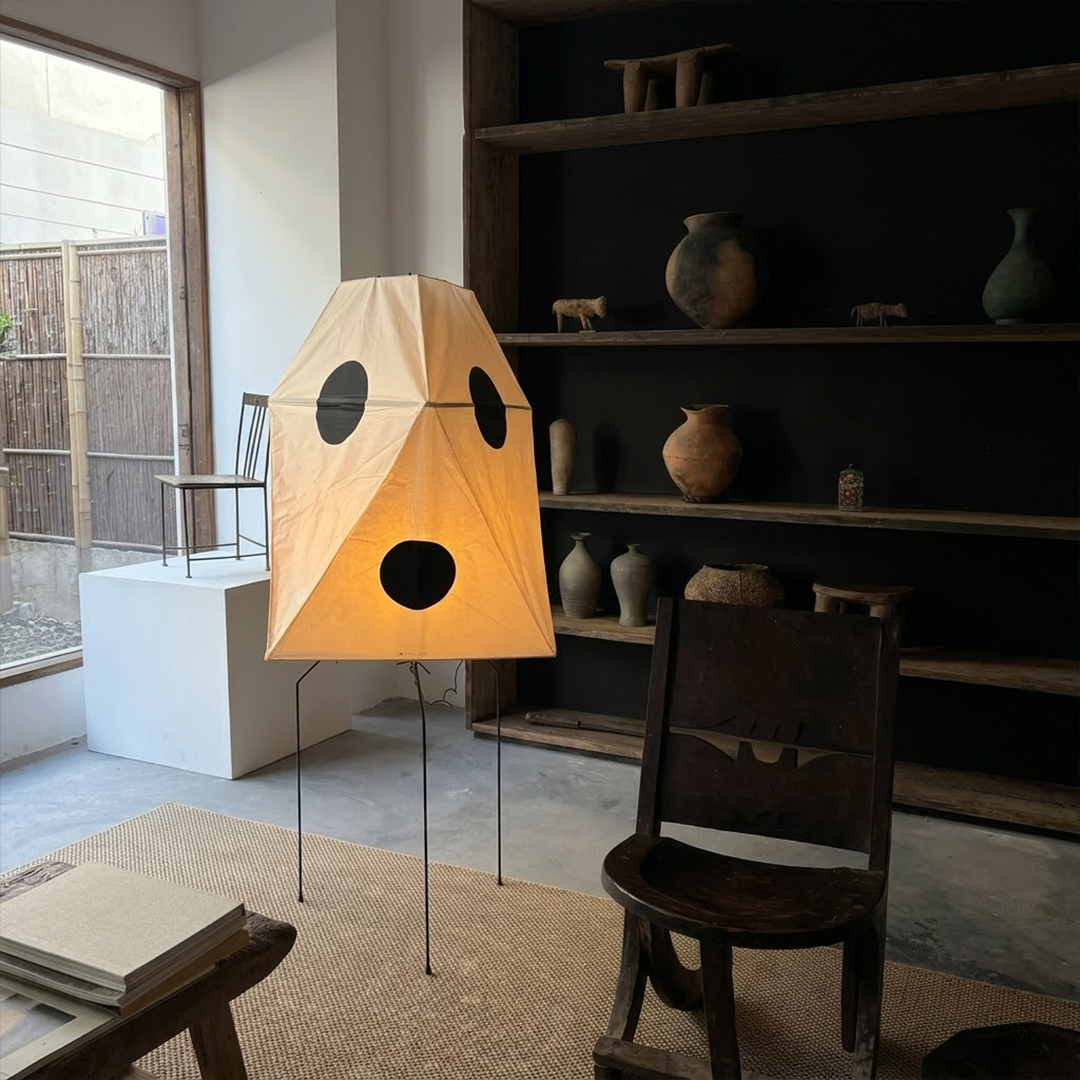 Akari UF3-Q floor lamp in a minimalist Japandi living room next to a designer chair.