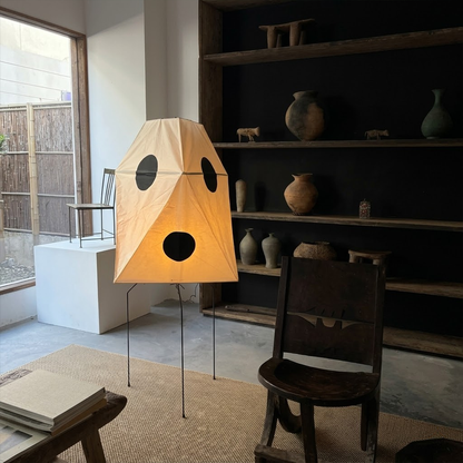 Akari UF3-Q floor lamp in a minimalist Japandi living room next to a designer chair.