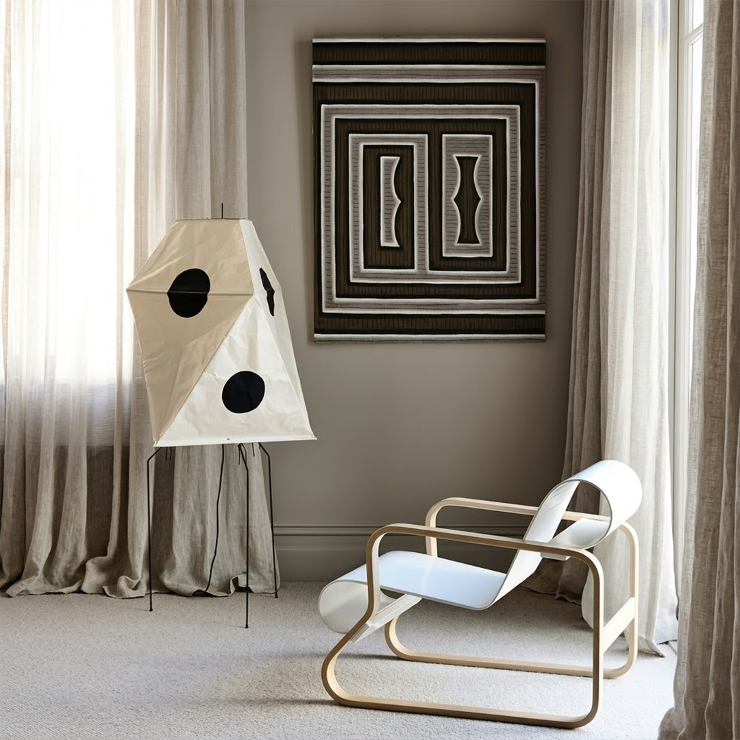 Akari UF3-Q floor lamp in a minimalist Japandi living room next to a designer chair.