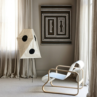 Akari UF3-Q floor lamp in a minimalist Japandi living room next to a designer chair.