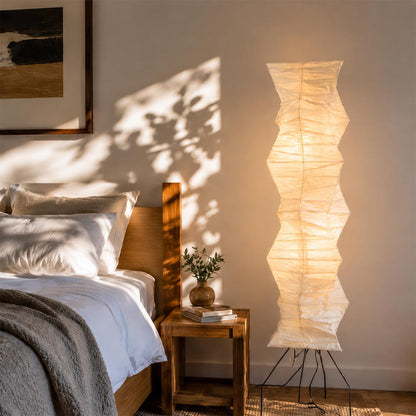 Warm ambient lighting from Akari UF4 33N tall rice paper floor lamp by the bedside - stuberlighting