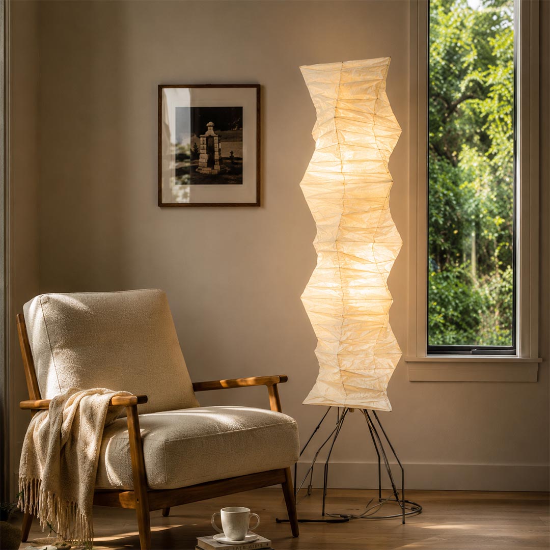 Modern tall rice paper Akari UF4 33N floor lamp next to armchair - stuberlighting