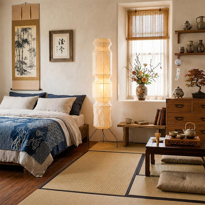 Minimalist Japandi bedroom interior with Akari UF4-L6 rice paper floor lamp near tatami bed - stuberlighting