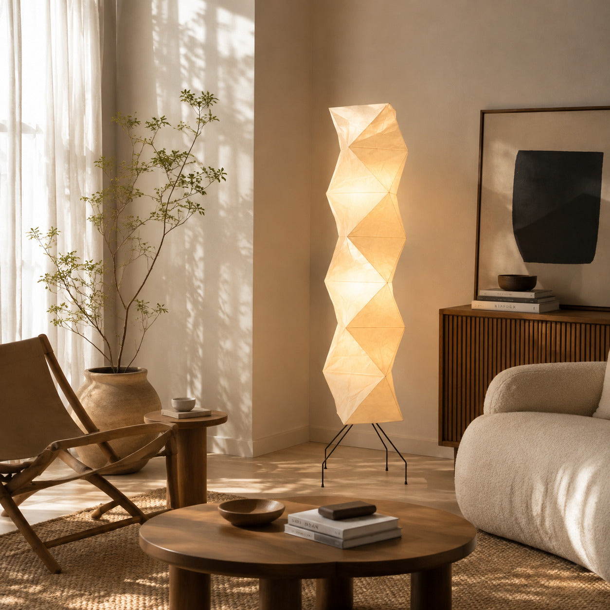 Akari UF4-L8 floor lamp beside sofa living room soft glow washi paper tall sculptural American home lifestyle interior styled