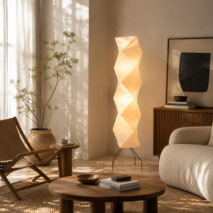 Akari UF4-L8 floor lamp beside sofa living room soft glow washi paper tall sculptural American home lifestyle interior styled